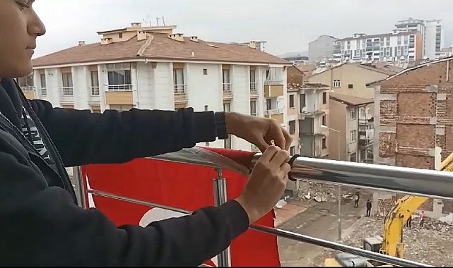 Yerdeki Türk bayrağını önce kaldırıp öptü, ardından yıkayıp balkona astı